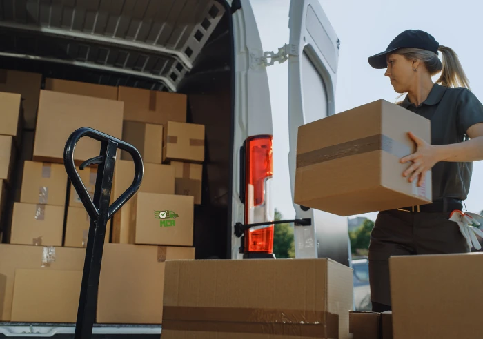 Trusting moving company female worker safely loading truck for relocation